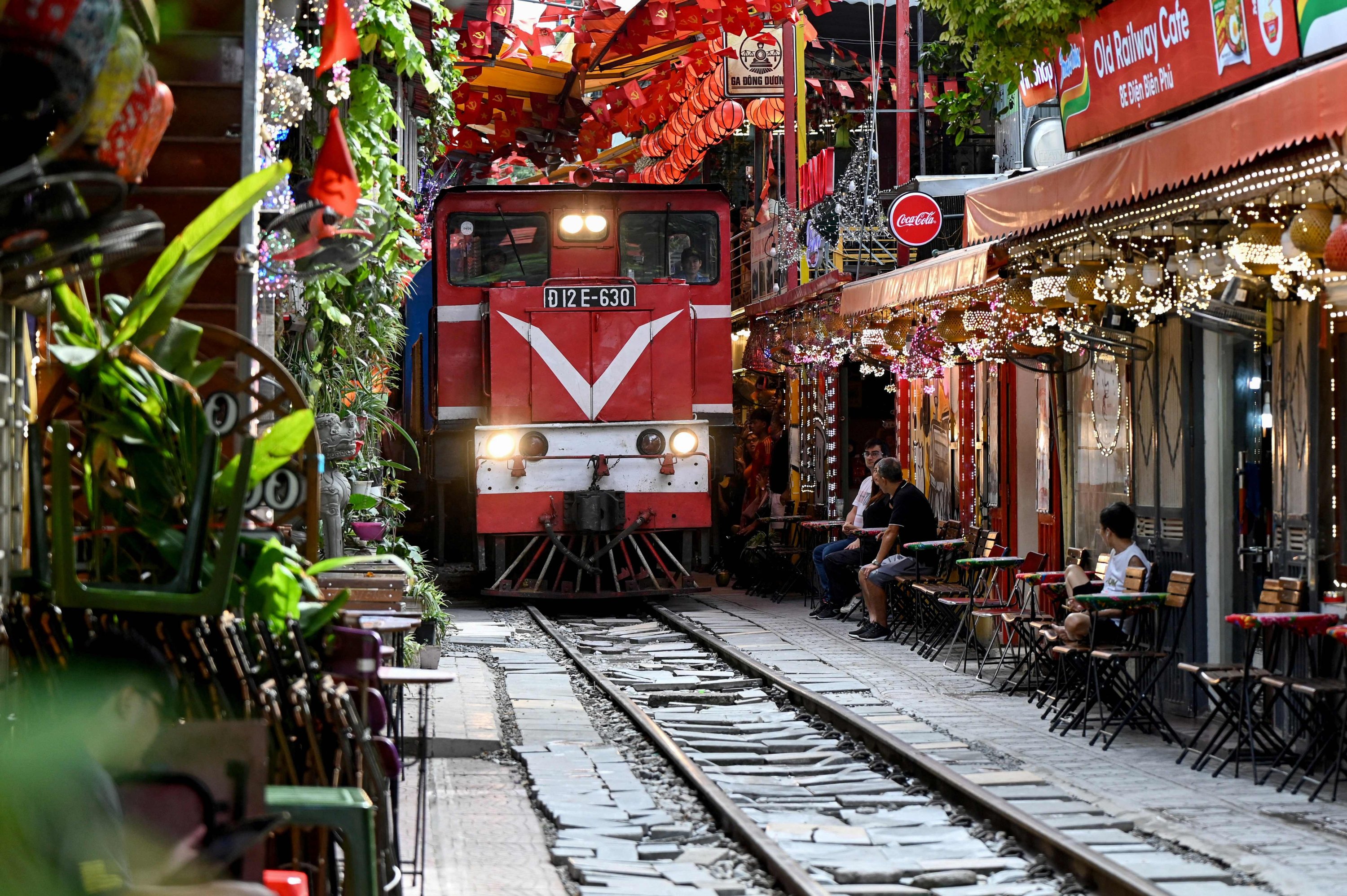 Visitors enjoying drinks beside the railway in Hanoi