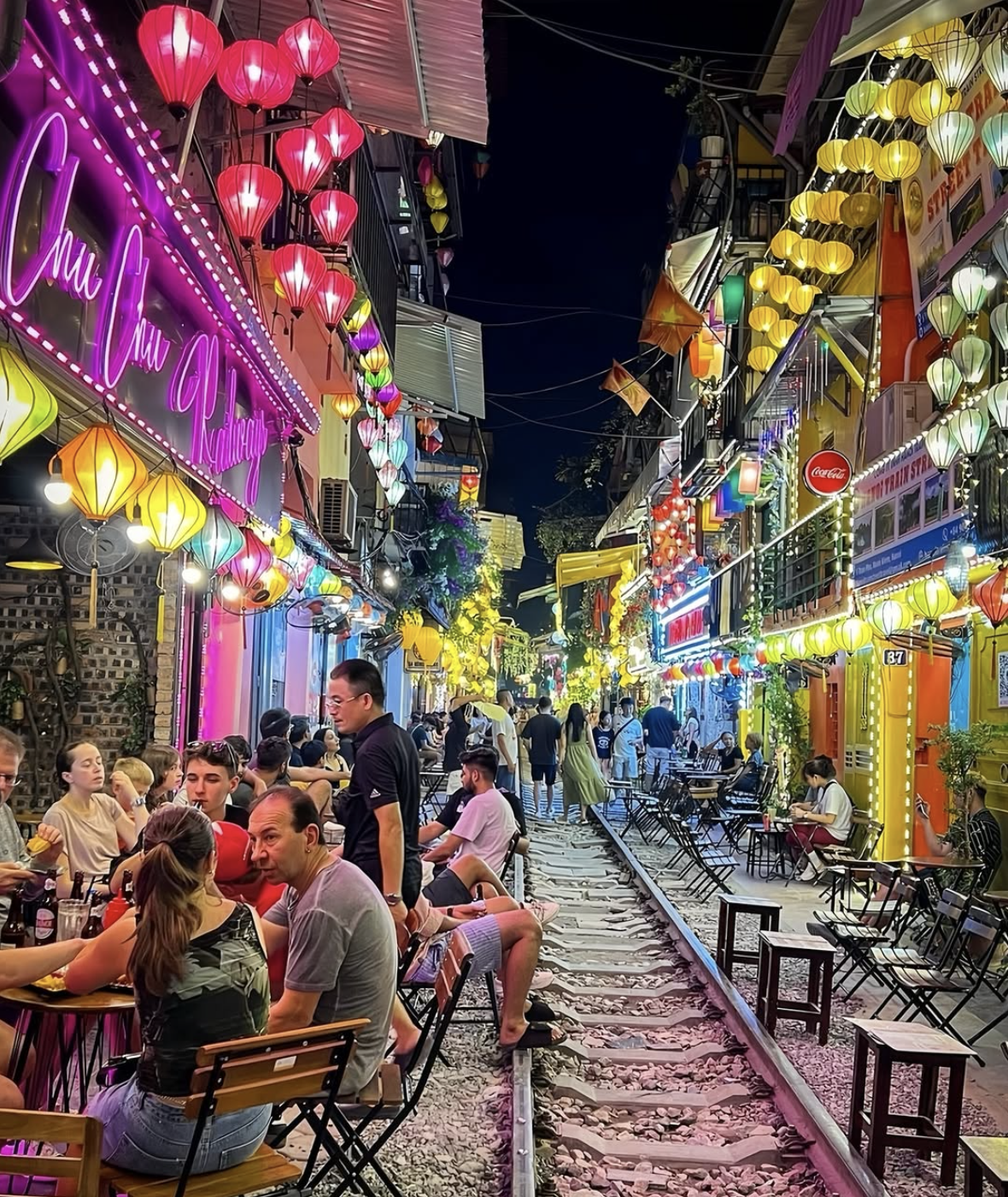 title Hanoi Train Street night view with train lights and evening schedule